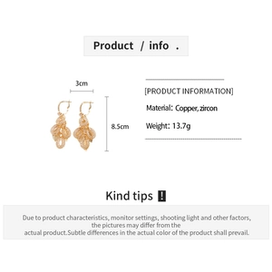 Detailed view of gold tassel earrings with zircon leaf design, 3cm wide and 8.5cm high