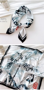 Detail of silk scarf with ink panda, bamboo patterns and red blessing seal stamp