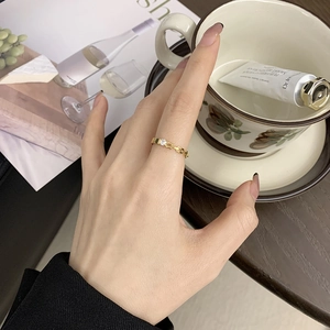 Minimalist 18K gold plated titanium chain link ring with small diamond on model's hand