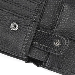 Macro detail of black litchi grain leather wallet with metal snap button and stitching