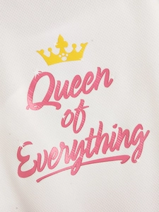 Macro detail of 'Queen of Everything' gold crown print on white breathable mesh fabric