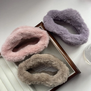 Three plush cloud hair claws in pink, purple, and coffee faux fur on a display tray