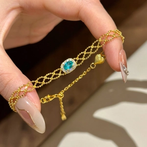 French vintage gold bracelet with blue oval gemstone and heart pendant on woven chain