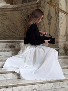Elegant white high waist A-line maxi skirt with pleats and flowing silhouette for women