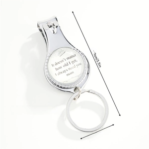 Detail view of silver metal keychain nail clipper with sentimental quote and dimensions