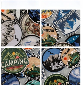 Detailed close-up of high-density embroidered outdoor mountain patches and camping badges