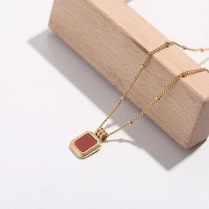 Minimalist 18K gold plated titanium necklace featuring a red square pendant and beaded chain
