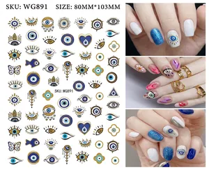 Detailed view of evil eye nail stickers with blue hearts and stars for bohemian manicures