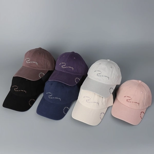 Detail shot of multicolor baseball caps with wraparound embroidery and six-panel cotton crown