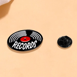 Vintage vinyl record enamel pin with red center and butterfly clutch backing