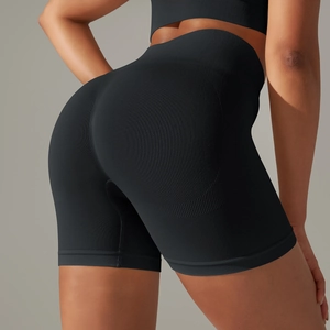 Rear view of high-waisted seamless black yoga shorts with peach butt lifting shapewear design
