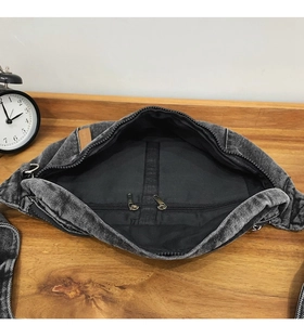 Top view of dark grey denim chest bag showing internal zipper pocket and storage space