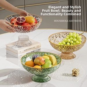 Close-up of diamond textured glass fruit bowls in amber and emerald with gold rims