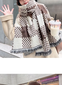 Detail of soft brown and beige checkered cashmere-feel scarf with fringe tassels