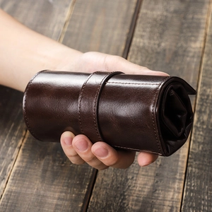 Porta orologi da viaggio in pelle cerata vintage con chiusura a cinturino in mano