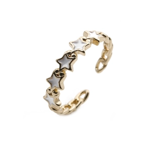 Detail of gold chain-style ring with five white enamel stars in an adjustable open design