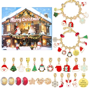 Detail of Christmas advent calendar with 24 gold DIY charms and holiday bracelets