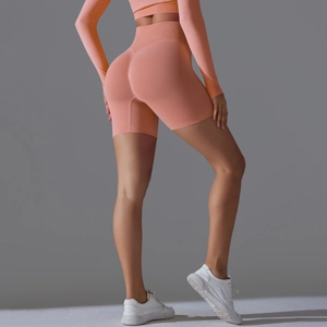 Detail view of seamless peach high waist yoga shorts with scrunch butt lifting design