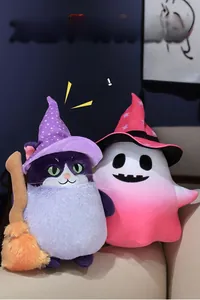 Close-up of Halloween plush cat wizard and ghost doll on a cozy beige sofa backdrop