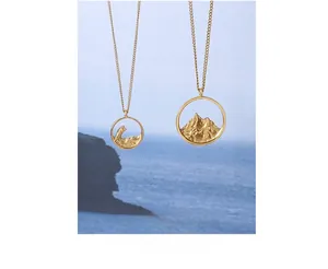 Detailed relief of mountain and wave pendants on golden necklaces for nature lovers