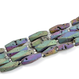 Macro detail of octagonal druzy agate beads with purple and green metallic luster finish