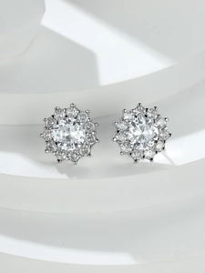 Macro detail of silver snowflake flower earrings with sparkling clear cubic zirconia stones