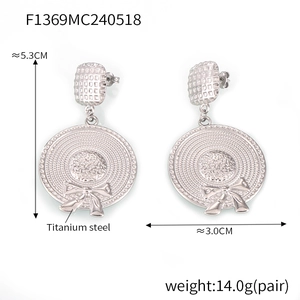 Detail showing titanium steel sun hat earrings with bow design in high-quality silver finish