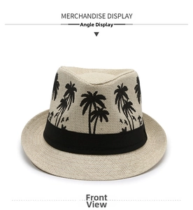 Detail of straw fedora hat featuring black palm tree prints and a grosgrain ribbon band