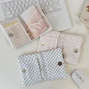 Detailed close-up of embroidered star passport wallet with magnetic closure and slots