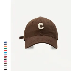 Detail view of cotton baseball cap featuring 3D letter C embroidery and canvas texture