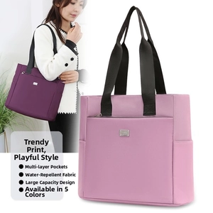 Water-resistant oxford cloth tote bag showing multi-layer pockets and large capacity