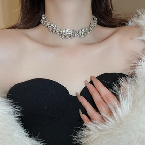 Close-up of a wide multi-layer silver twisted choker with sparkling rhinestones on neck