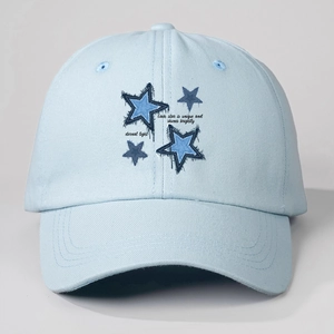 Detail of light blue washed cotton baseball cap featuring blue star embroidery and text