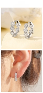 Detail of silver star zircon wreath earrings with a model wearing the jewelry