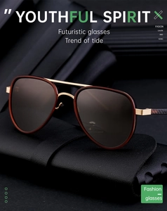 Close-up of pilot sunglasses with brown lenses and metal frame on a leather case