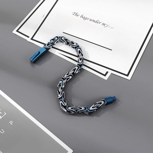 Detailed macro view of the blue and silver Byzantine weave steel chain with secure clasp
