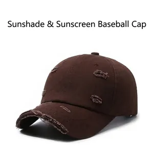 Close-up detail of a brown distressed baseball cap featuring vintage ripped edge design