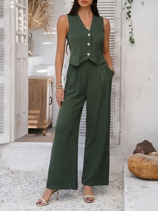Close-up of textured dark green linen vest and wide-leg trousers for a casual look
