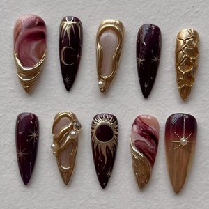 Handmade almond press-on nails with celestial star moon motifs and burgundy leopard patterns
