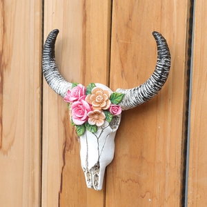 Floral resin bull skull wall decor with roses on vertical wooden planks background