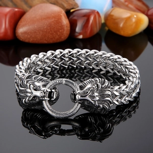 Macro shot of silver stainless steel lion head bracelet with woven link chain detail
