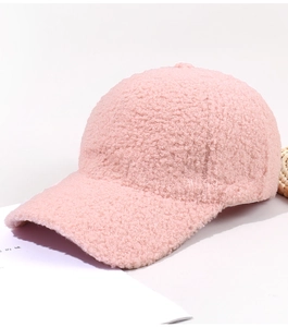 Close-up of pink fluffy teddy fleece baseball cap showing soft textured material
