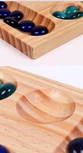 Detailed macro view of high-quality wooden Mancala board with blue glass gemstones