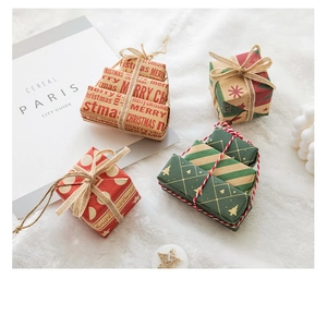 Close-up of festive Christmas gift boxes with twine on a soft white plush background