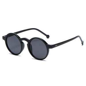 Retro round black sunglasses with dark lenses and silver stud details on a white backdrop