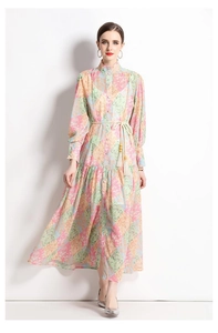 Close-up of ethnic floral print maxi dress with stand collar and woven tassel belt detail