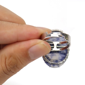 Handmade silver wire-wrapped tree of life ring with blue oval crystal stone
