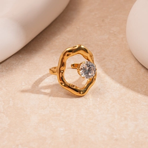 Detail of gold irregular lava-style ring featuring a floating round cut zircon stone
