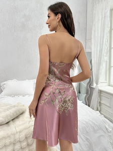 Close-up of pink satin floral slip dress showing backless design and silky texture