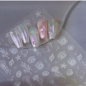 Detail of ocean themed nail stickers featuring jellyfish and starfish with laser finish